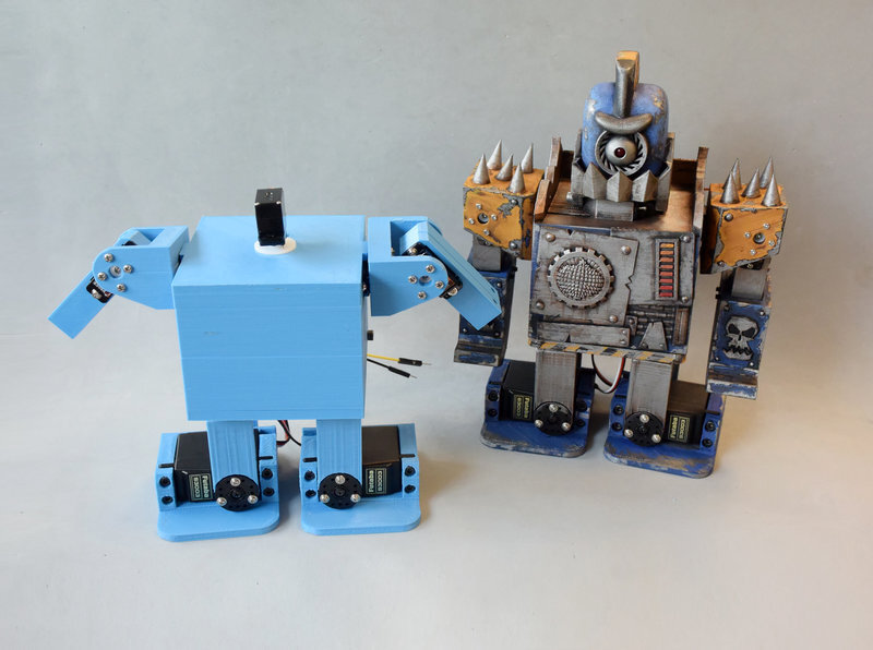 A finished zowimanoid next to a customized one
